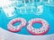 Two Pink Float Rings In A Swimming Pool