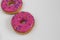 Two Pink Glazed & Sprinkled Donuts