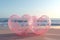 Two pink Heart-shaped transparent bubbles on the beach for wedding decoratio