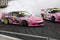 Two pink Nissan drifting cars positioned close to each other.