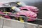 Two pink Nissan drifting cars positioned close to each other.