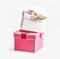 Two pink and white gift boxes with ribbon and heart stapled at white background. Beautiful decorated presents for celebration.