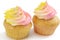 Two pink and yellow cupcake, on white