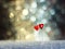 Two pins hearts on festive shimmering background
