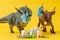 Two plastic dinosaurs with face masks and groceries