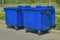 Two plastic trash recycling containers. Blue containers for collecting garbage on the dustbin