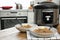 Two plates with delicious buckwheat and modern multi cooker on wooden table