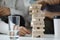 Two players take turns removing wooden blocks from tower