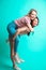Two playful interacial girls piggybacking and having fun at studio