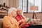 Two pleasant-looking elderly grey-haired women discussing photos online