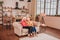 Two pleasant-looking elderly grey-haired women sitting on the sofa