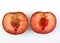 Two plum halves on white background.