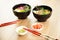 Two poke salads with beef and tuna in a bowl on a restaurant table. Poke salads in a bowl next to chopsticks and ginger