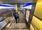 Two policeman walk in the illuminated underground corridor