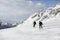 Two policemen on skis. Police in a ski resort. Rescuers in the mountains. the policeman descends on skis. Valbona, Lusia, Bellamon