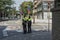 Two policemen stand at the crossroads of a city street
