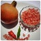 Two Pomegranate with Pomegranate seeds in bowl with shiny red â€œjewelsâ€ inside and its flower buds kept in bowl and placed