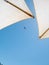 Two pool umbrellas on the background of the plane in the blue sky