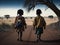 Two poor African girls walking under a dry tree in a desert