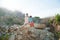 Two poor refugee children boy girl on ruins building destroyed by war