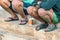 Two port workers taking a break sitting with sandals on their feet and having cold coffee in Heraklion, Greece