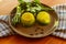 Two portions of frozen green broth on a dark plate, close-up