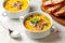 Two portions of Hearty chicken mushroom soup with wild rice in a white bowl