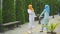 Two positive Muslim young women dancing in the park