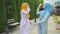 Two positive Muslim young women dancing in the park close up