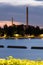 Two powerplant smokestacks standing behind a leisure island on the waterfront