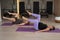 Two pregnant women doing Pilates with special small fit balls.
