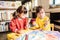 Two preschool girls playing and coloring pictures in rehabilitation center