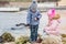 Two preschoolers actively playing on stony beach
