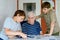 Two Preteen Boys Teaching Grandfather How to Use Internet Safely. Teenage Brothers, School Children with Digital Tablet