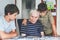 Two Preteen Boys Teaching Grandfather How to Use Internet Safely. Teenage Brothers, School Children with Digital Tablet