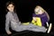 Two preteen girls sitting on ground wearing fun eye glasses