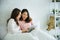 Two pretty best friends forever girlfriend talk, hug and laugh together on bed at cozy home relation fall in love. Lesbian couple