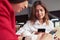 Two pretty busy females working in smartphones and drinking coffee