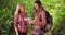 Two pretty Caucasian female hikers looking at maps while on nature trail