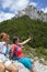 Two pretty female women photographing a selfie on mountain peak