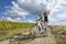 Two pretty girls on bike tour on path