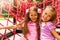 Two pretty girls hugging on rope of playground