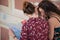 Two pretty girls are looking at a map on stairs