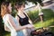 Two pretty girls making food on grill