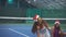 Two pretty girls sit on the tennis court in the New Year`s accessories