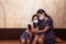 Two pretty girls taking a selfie with the mobile phone. Mother and daughter wearing face mask and sitting on the subway station