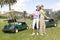 Two pretty golf player with her golf cars
