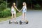 Two pretty happy girls riding on hover board or gyroscooter outdoors at sunset in summer. Active life concept