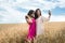 two pretty sister enjoy freedom in wheat field