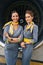Two pretty stewardesses standing by the aeroengine